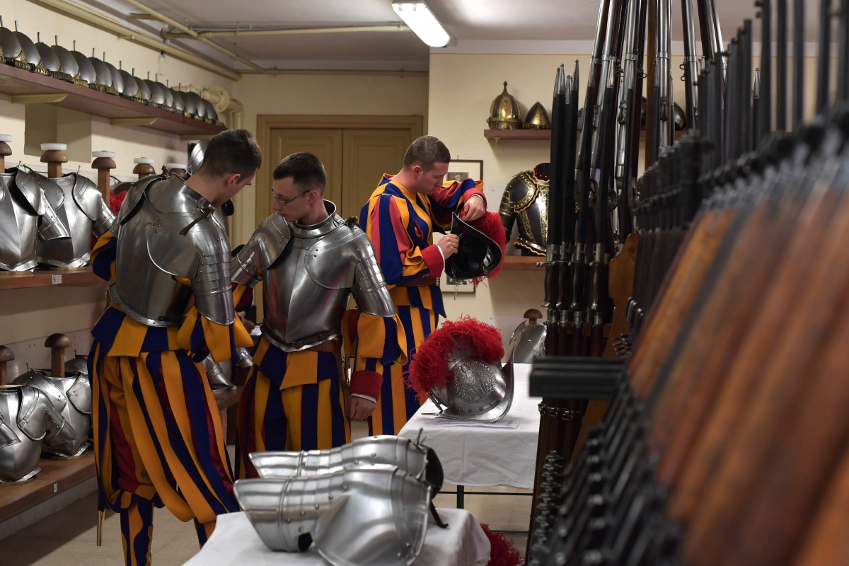 New Vatican Swiss Guards put on and adjust their uniforms prior to a swearing-in ceremony in Vatican City, on May 6, 2017. The annual swearing in ceremony for the new papal Swiss guards takes place on May 6, commemorating the 147 who died defending Pope C