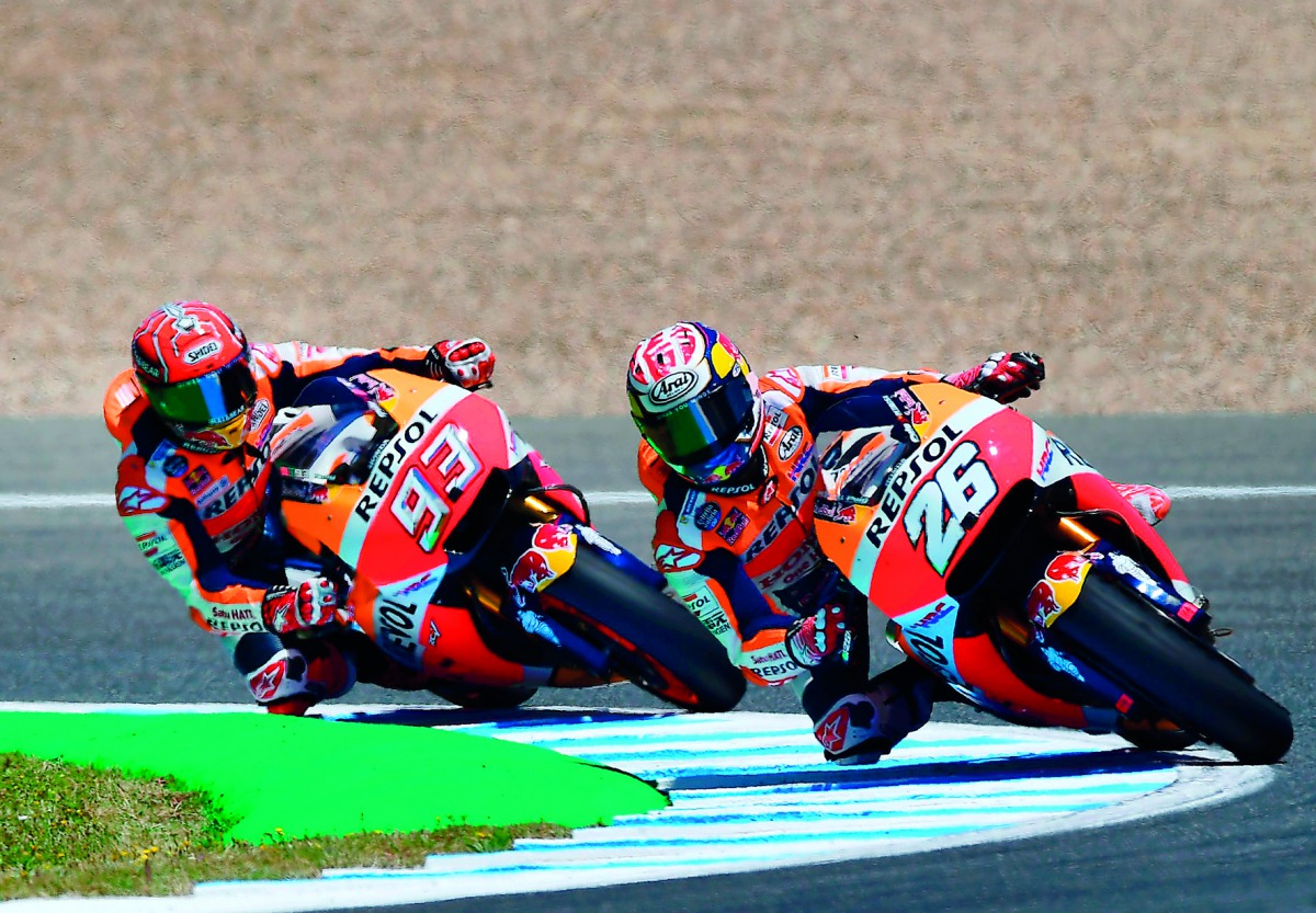 Repsol Honda Team's Spanish rider Dani Pedrosa (right) and his team-mate Marc Marquez of Spain take a curve at Jerez de la Frontera race track during the MotoGP fourth free practice session of the Spanish Red Bull Grand Prix.