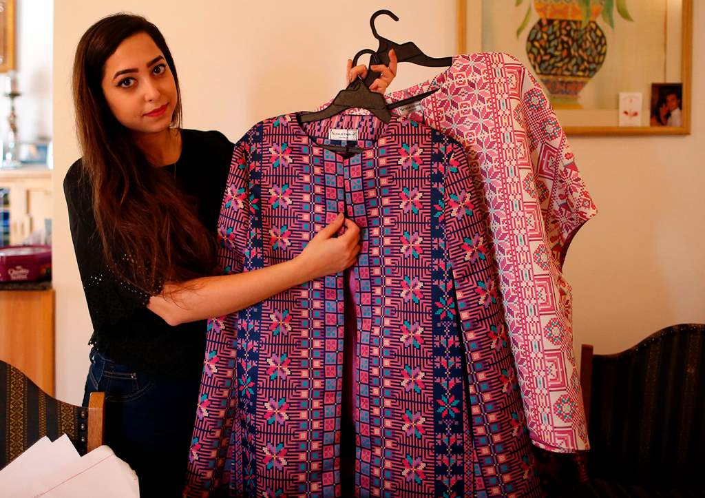 Palestinian fashion designer Natalie Tahhan displays some of her creations at her studio in the east Jerusalem neighbourhood of Ras al-Amud on April 13, 2017. AFP / AHMAD GHARABLI
