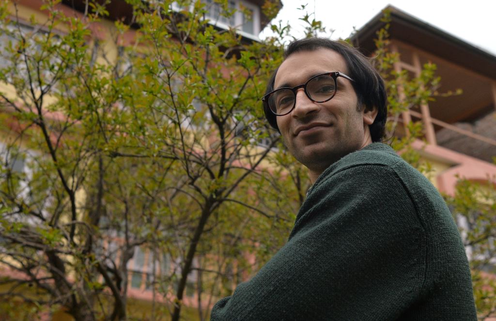 In this photograph taken on April 20, 2017, Kashmiri cartoonist Malik Sajad poses for a photograph at his home in Srinagar. AFP / TAUSEEF MUSTAFA 