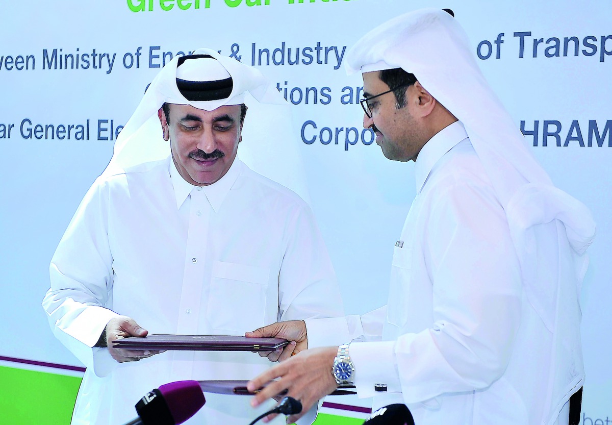 H E Jassim bin Saif Al Sulaiti (left), Minister of Transport and Communication, and H E Dr Mohammed bin Saleh Al Sada, Minister of Energy and Industry, exchanging the MoUs on the Green Car Initiative, yesterday. Pic: Baher Amin / The Peninsula