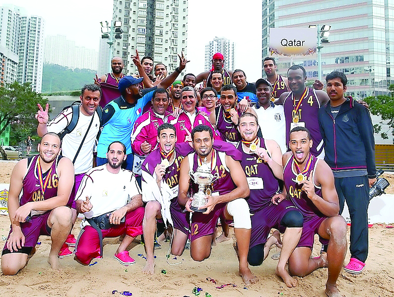 This file photo shows Qatar beach handball team's members and officials pose for a picture after winning the 2013 edition of Asian Beach Handball Championship in Hong Kong. Qatar will take Oman today in their last Group A match at the ongoing Asian Beach 