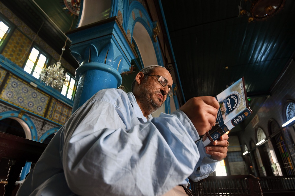 Tunisian Rabbi Daoud reads the torah at the Ghriba Synagogue on the Tunisian resort island of Djerba on May 14, 2017 during the second day of the annual Jewish pilgrimage to the synagogue thought to be Africa's oldest. AFP / Fethi Belaid