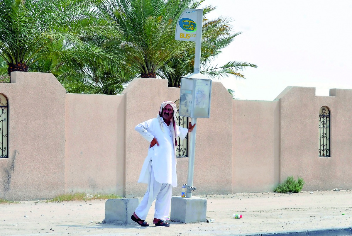 A man waiting for bus in hot weather at Al Wakrah- Doha Road yesterday.  Pic: Kammutty VP / The Peninsula