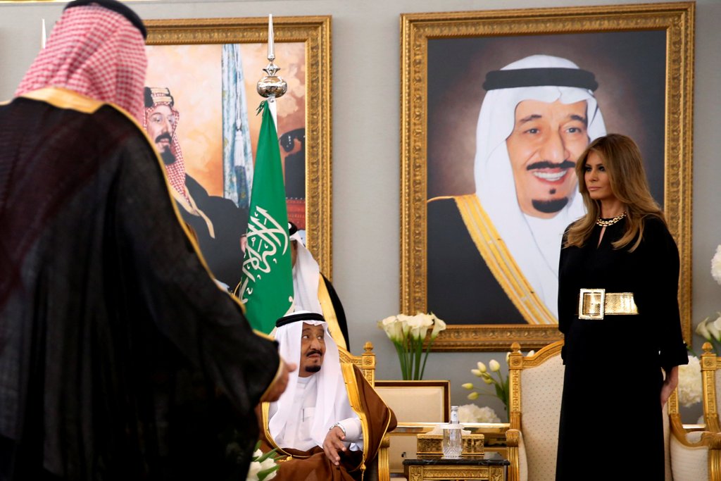 U.S. first lady Melania Trump (R) takes her seat next to The Custodian of the Two Holy Mosques King Salman bin Abdulaziz Al Saud of Saudi Arabia (seated-L) as he welcomes her and U.S. President Donald Trump (not pictured) with a coffee ceremony in the Roy