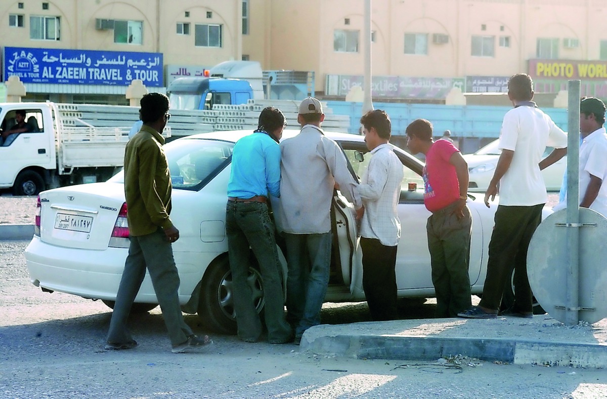 Labourers bargaining with an illegal car driver.