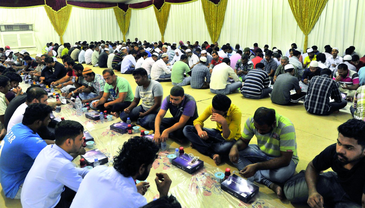 People have the Iftar meal at a Sheikh Thani Bin Abdullah Al Thani Foundation for Humanitarian Services (RAF) and Qatar Airways tent in old Airport Area, yesterday. Pic: Kammutty VP / The Peninsula