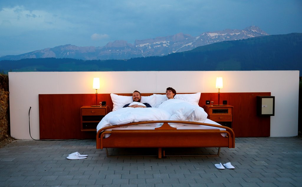 Raphael and Mirjam (R) pose as first guests in the bedroom of the Null-Stern-Hotel (Zero-star-hotel) land art installation by Swiss artists Frank and Patrik Riklin on an alp near Gonten, Switzerland June 1, 2017. REUTERS/Arnd Wiegmann 