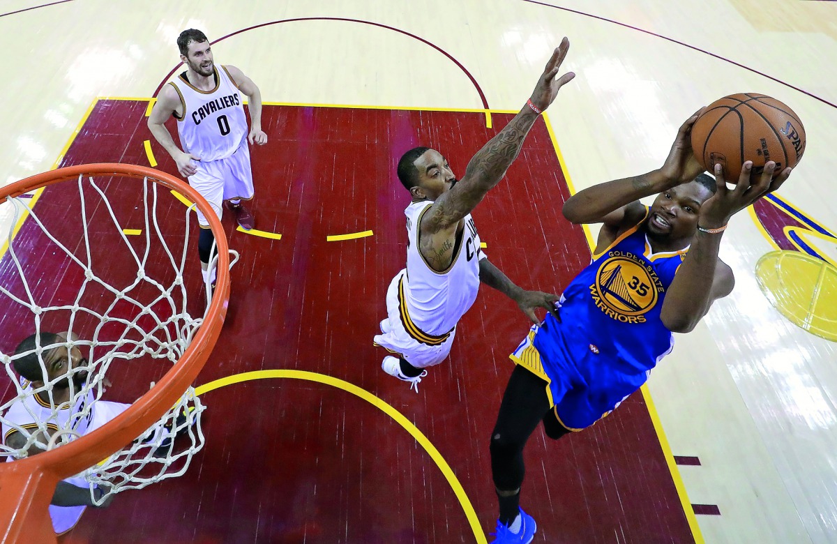 Golden State Warriors forward Kevin Durant (right) shoots the ball against Cavaliers JR Smith (5) in game 3 of the 2017 NBA Finals on Wednesday.