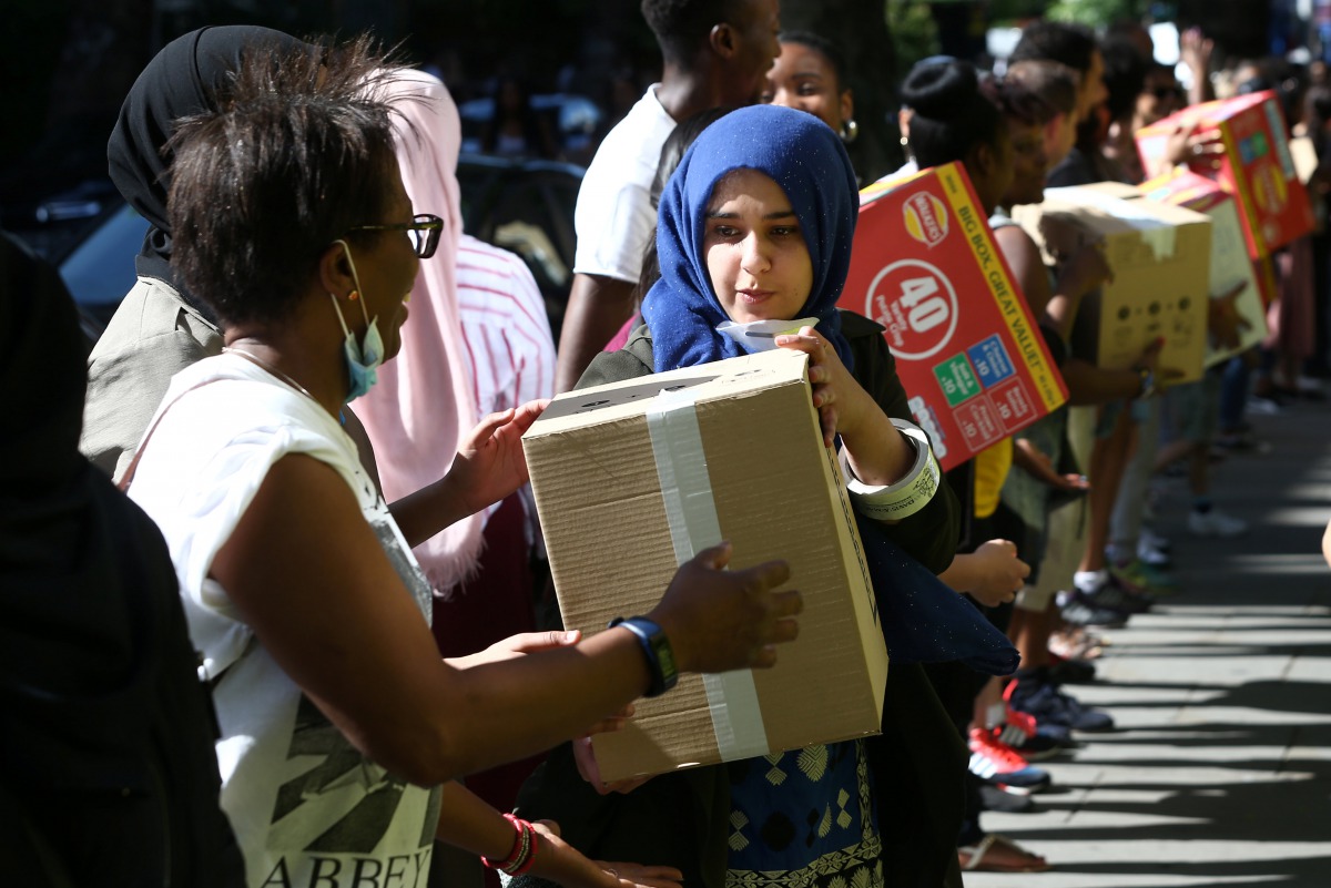 Volunteers prepare supplies for people affected by the Grenfell Tower block which was destroyed in a fire, in north Kensington, West London, Britain June 15, 2017. Reuters/Neil Hall