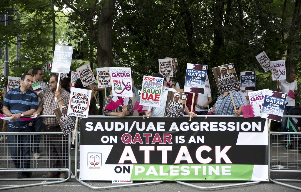 People hold placards during a protest against the Saudi-UAE led aggression on Qatar in an emergency protest called by the international campaign for Justice & Peace outside the United Arab Emirates Embassy in London, United Kingdom on June 17, 2017. (Isab