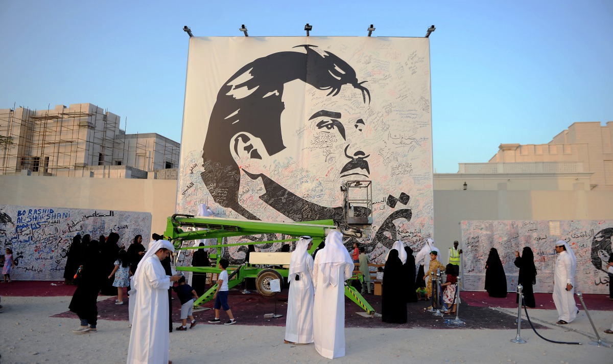 people signing on the Huge painting of Emir HH Sheikh Tamim bin hamad al Thani to show there solidarity with the leadership in this hour of crisis on Monday in Al Gharafa. Pictures: Abdul Basit