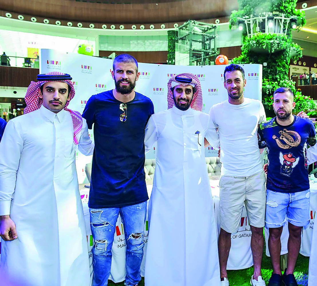 Sergio Busquets, Jordi Alba, and Gerard Pique with fans at Mall of Qatar. 
