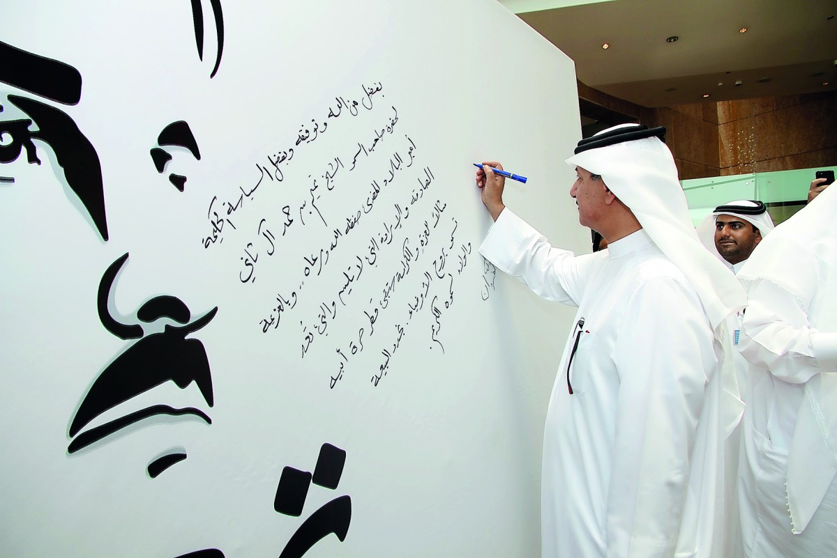 Sheikh Abdullah bin Ali bin Jabor Al Thani, Chairman of the Board of Directors of Commercial Bank, signing on the board.