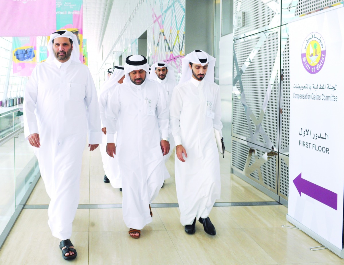 Salim Rashid Al Muraikhi (left), Assistant Undersecretary for Legal Affairs of the Ministry of Justice, with other officials during a visit to Compensation Claims Committee headquarters at the Doha Exhibition and Convention Center, yesterday. 