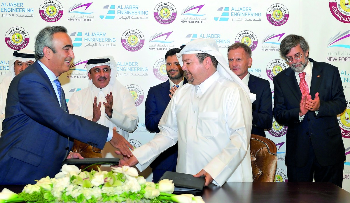 The New Port Project Executive Director, Maisar Jamil El Qutami (third right), shakes hands with CEO of Al Jaber Engineering, Osama Hadid, after signing an agreement in the presence of Minister of Transport and Communications H E Jassim bin Saif Al Sulait