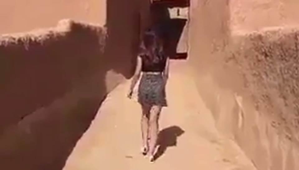 The Saudi woman, identified as Model Khulood, appeared on a Snapchat clip strolling through an empty mudbrick village alleyway, wearing a short skirt and a top that exposed her midriff.