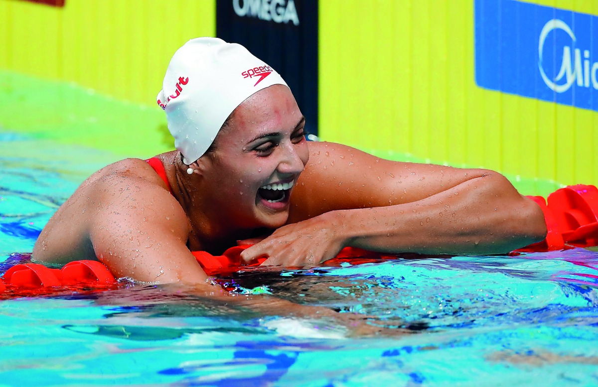 Kylie Masse of Canada reacts after winning the race and breaking a world record.