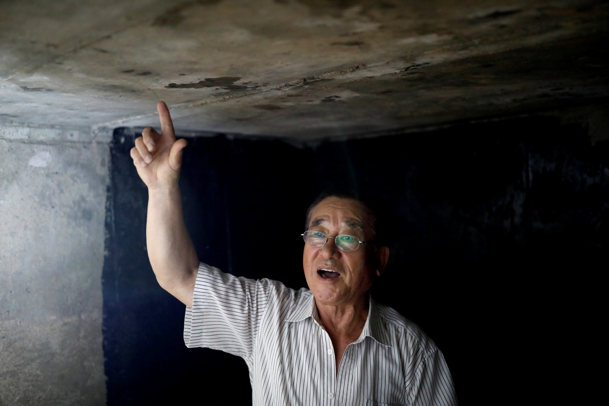 Resident Woo Jong-il speaks inside his private bunker at his house near the demilitarized zone separating the two Koreas in Paju, South Korea, July 14, 2017. Reuters/Kim Hong-Ji