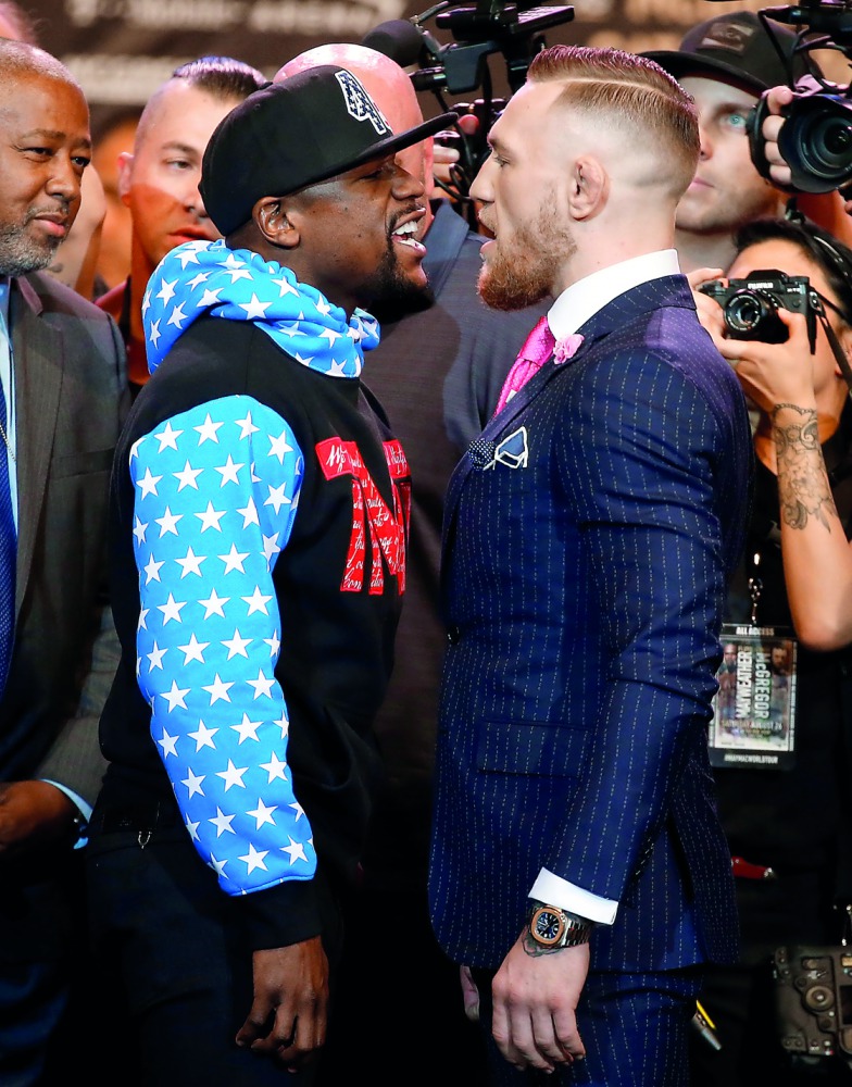 Floyd Mayweather Jr. (left) and Conor McGregor stand face to face during the Floyd Mayweather Jr. vs Conor McGregor World Press Tour at Staples Center in Los Angeles, in this July 12, 2017 file photo. 