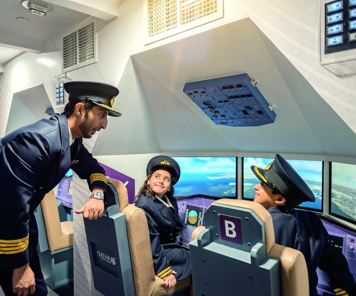 Qatari Captain Al Yafei Abdulaziz providing an opportunity to eight year-olds Maryam Mahasneh and Bader Albanna at a specially-adapted aircraft at KidzMondo at the Mall of Qatar.