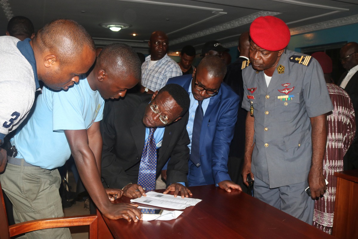 Fontem Aforteka'a Neba (3rd L) and Felix Agbor Balla (2nd R) two Anglophone activists leaders prepare to sign a document during their release at the prison of Yaounde, Cameroon, September 1, 2017. REUTERS