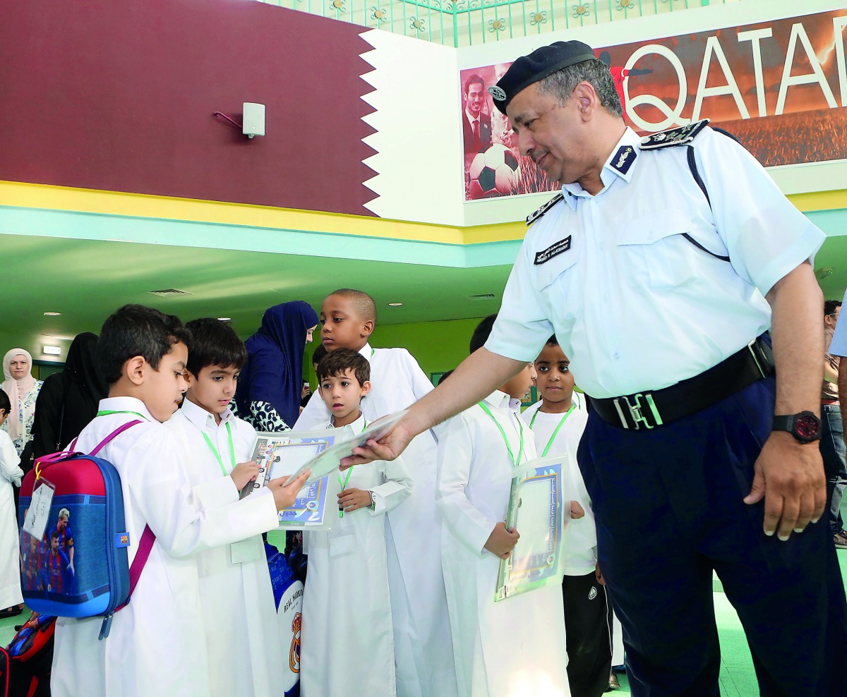 Brigadier Mohammed Saad Al Kharji, Director of the General Directorate of Traffic Department, distributing gifts to students at Omar Bin Al-Khattab Independent Second Primary School for Boys.