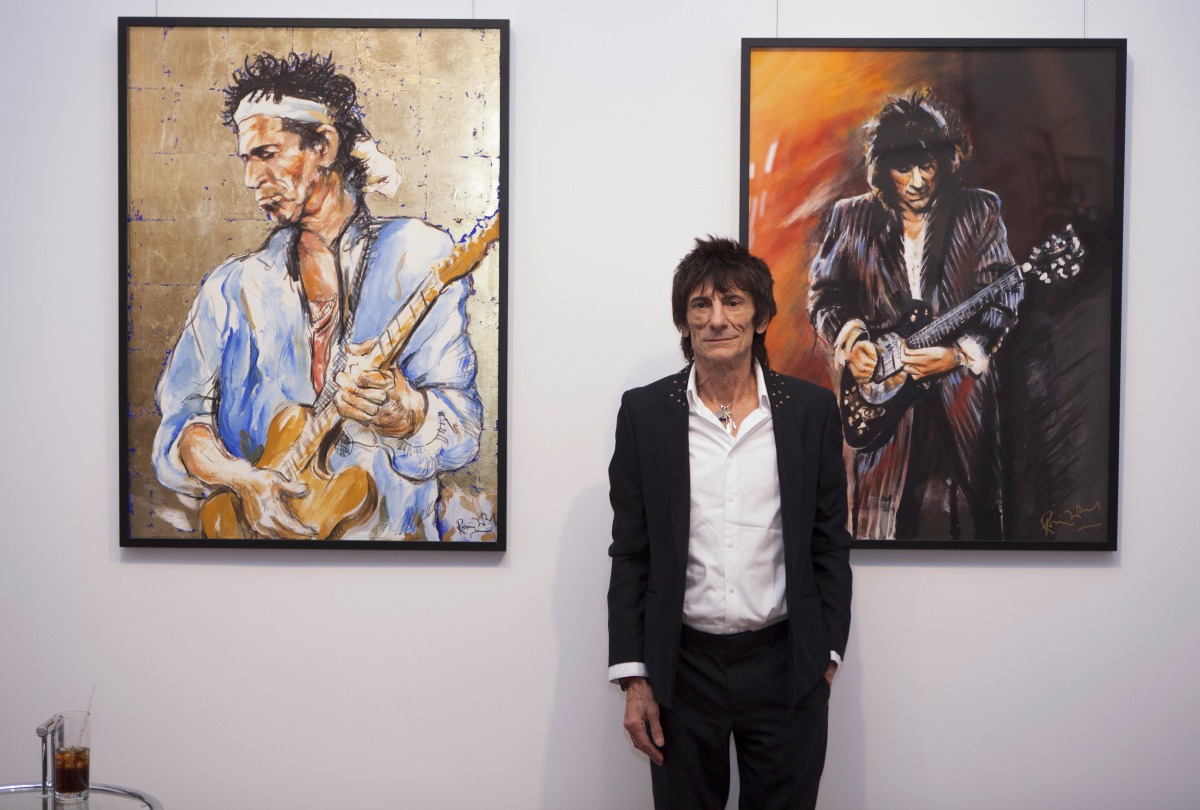 Rolling Stones guitarist Ronnie Wood discusses his art during a news conference at his 