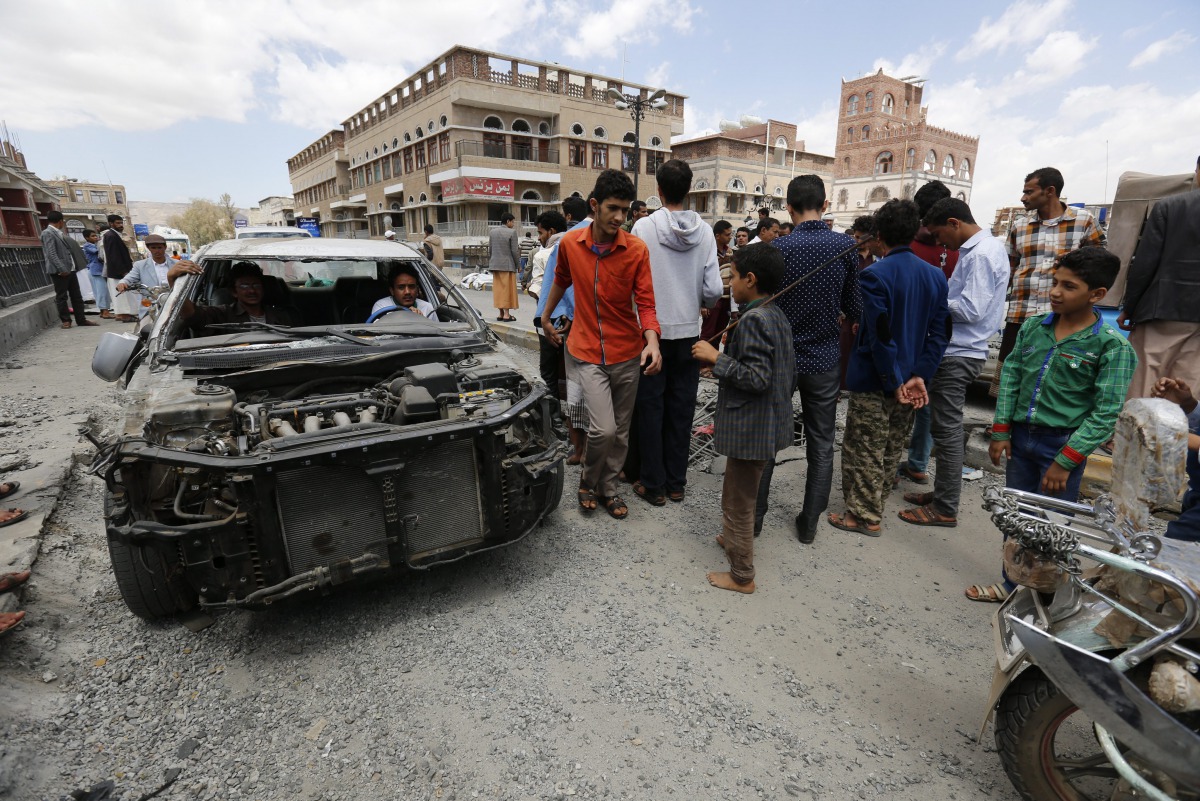 Yemenis inspect the site of a Saudi-led airstrike on a bridge two people were killed and three injured, Sanaa, Yemen, March 23, 2016.  (EPA Yahya Arhab) 