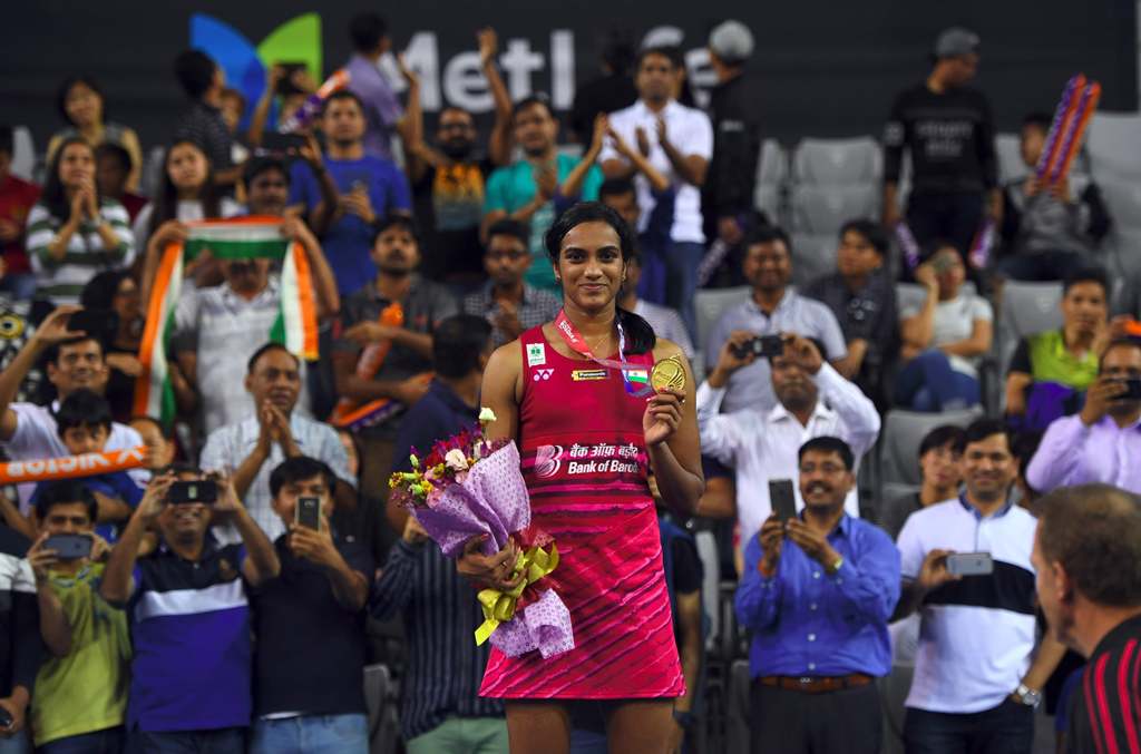 India's Pusarla V Sindhu poses on the podium during an awards ceremony after the women's singles final match against Japan's Nozomi Okuhara at the Korea Open Badminton Superseries in Seoul on September 17, 2017. (AFP / JUNG Yeon-Je)