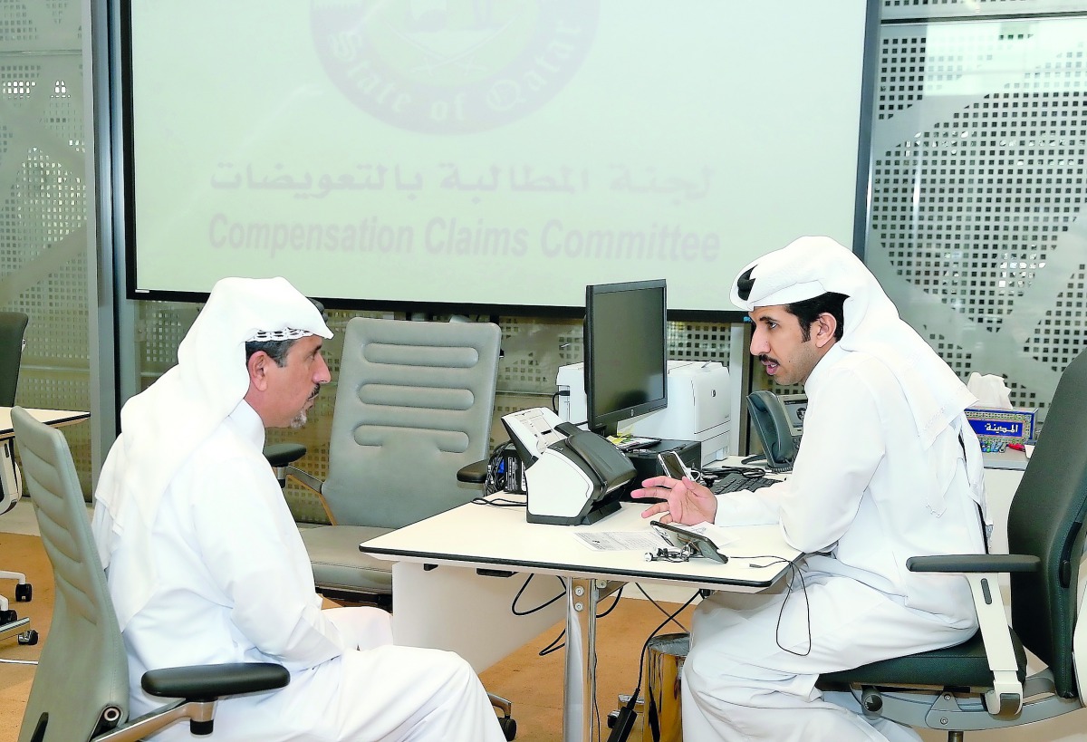 A member of the Compensation Claims Committee receiving a complaint from a citizen.