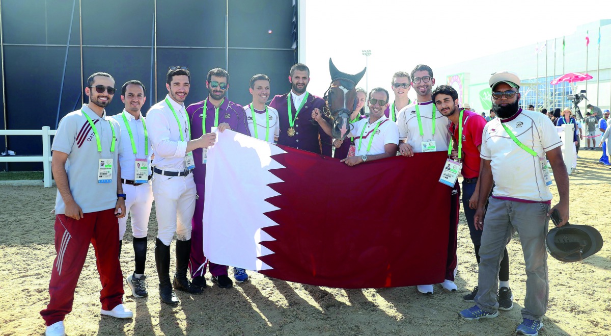 Victorious Qatari rider Hamad Ali Al Attiyah (centre) poses for a photograph with his horse, Clinton and team-mates after the victory ceremony during the 5th Asian Indoor and Martial Arts Games in Ashgabat, Turkmenistan yesterday.