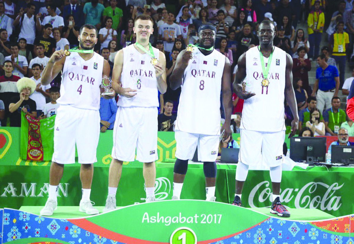 Qatari basketball players Erfan Saeed, Tanguy Ngombo, Abdulrahman Saad and Nedim Muslic pose for photographs on the podium after winning the gold medal, beating Iraq 22-12 in the men’s 3x3 basketball final during the 5th Asian Indoor and Martial Arts Game