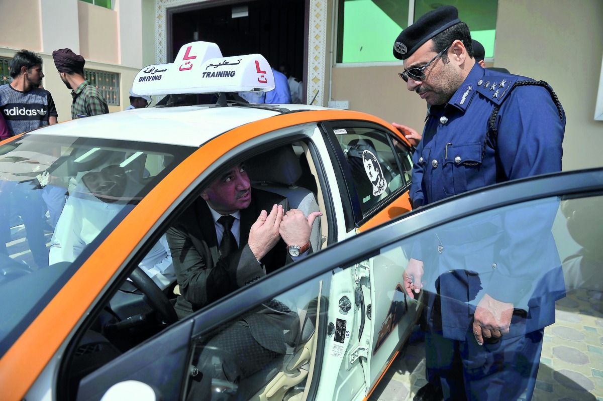 Amir Al Mulla (left), Executive Director of the Qatar Society for Rehabilitation of People with Special Needs; Hassan Nassar, Manager at Dalla Driving Academy; and Brigadier General Saqar Al Muraikhi, Head of the Licensing Affairs Section at the Traffic D