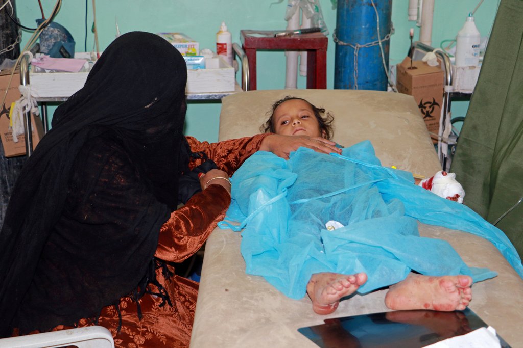 A woman sits next to her daughter who was injured in a Saudi-led air strike, at the hospital in the northwestern city of Saada, Yemen, yesterday.