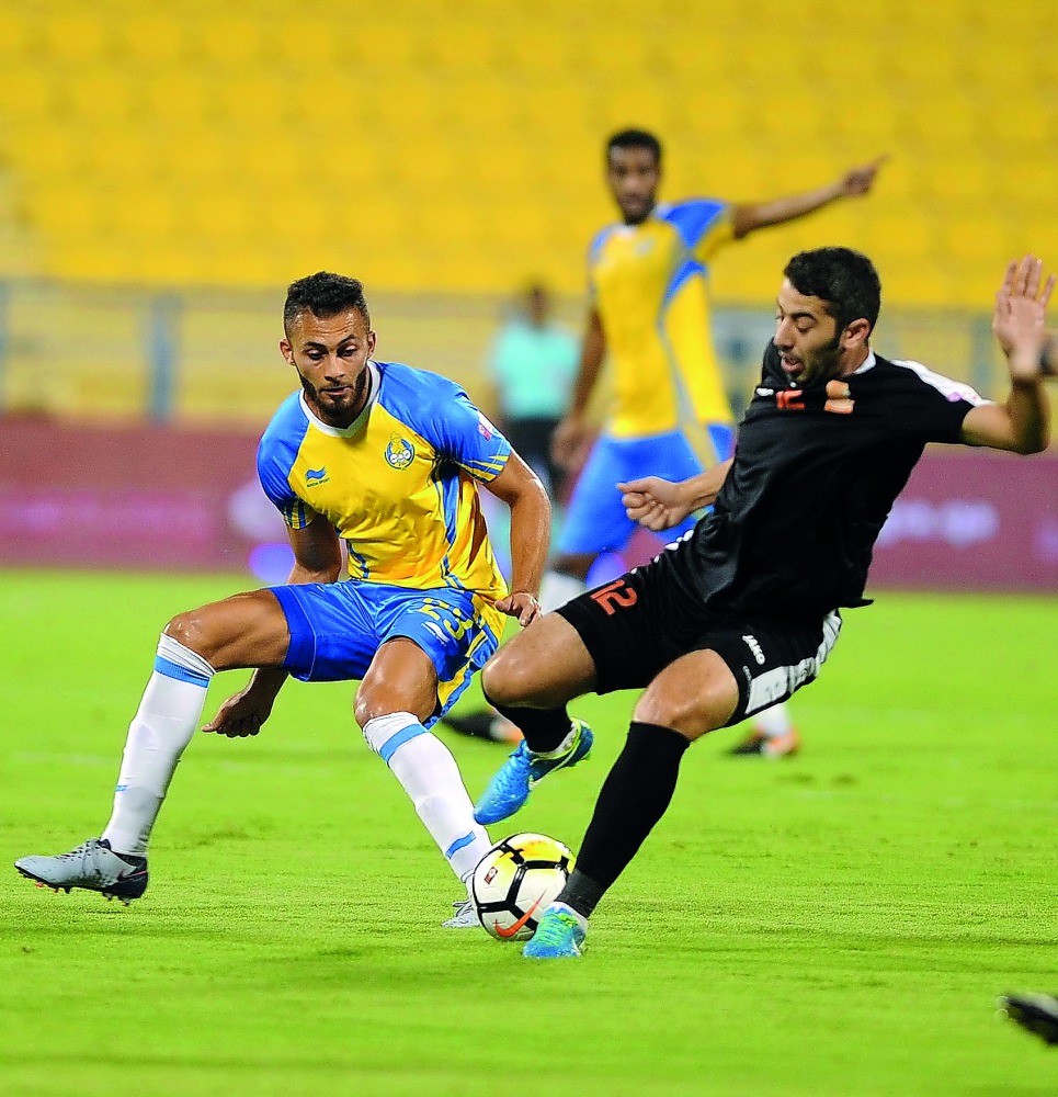 Al Gharafa’s Khaled Abdelraouf Al Zrigi (left) and Dheyab Hassan Al Inabi vie for the ball possession during their QNB Stars League (QSL) match at Al Gharafa Stadium in this September 22 file picture.