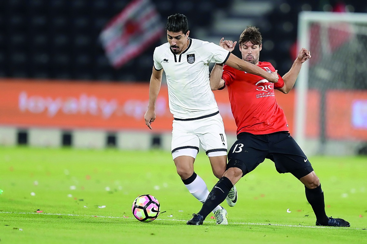 Al Sadd’s Baghdad Bounedjah (left) and Al Rayyan’s Gonzalo Viera in action during a QSL match in this file photo. Bounedjah is expected to be back in action in the  game against Qatar SC on Sunday. 