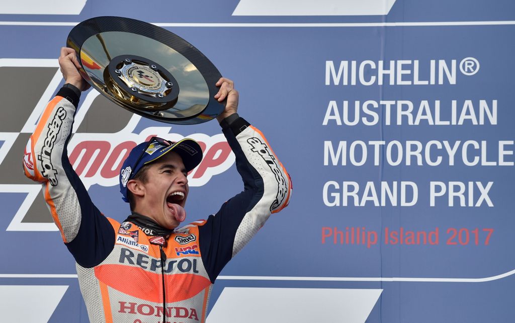 Honda rider Marc Marquez of Spain celebrates his victory on the podium at the end of the Australian MotoGP Grand Prix at Phillip Island on October 22, 2017. AFP / PETER PARKS