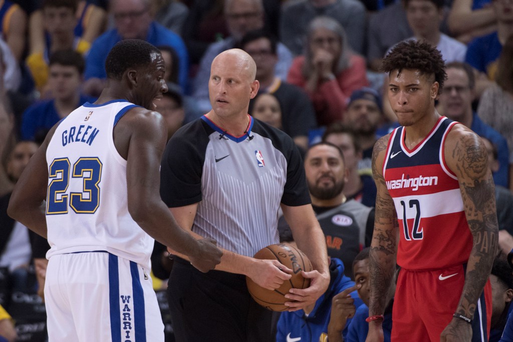 Golden State Warriors forward Draymond Green (23) argues with NBA referee Eric Dalen (37) in front of Washington Wizards forward Kelly Oubre Jr. (12) during the second quarter at Oracle Arena.  Kyle Terada
