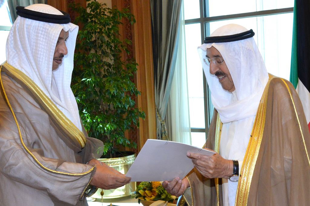 A handout photo provided by the Kuwaiti news agency KUNA shows Kuwaiti Prime Minister Sheikh Jaber al-Mubarak al-Sabah (L) handing over the government's resignation letter to the Emir of Kuwait Sheikh Sabah al-Ahmad al-Sabah on October 30, 2017, in Kuwait