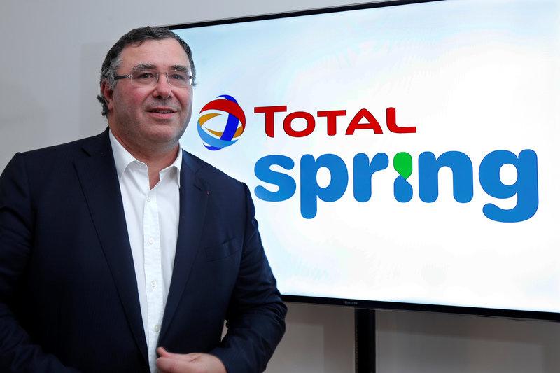 Total Chief Executive Officer Patrick Pouyanne poses next to the logo of Total Spring during a news conference in Paris, France, October 5, 2017. Reuters/Charles Platiau