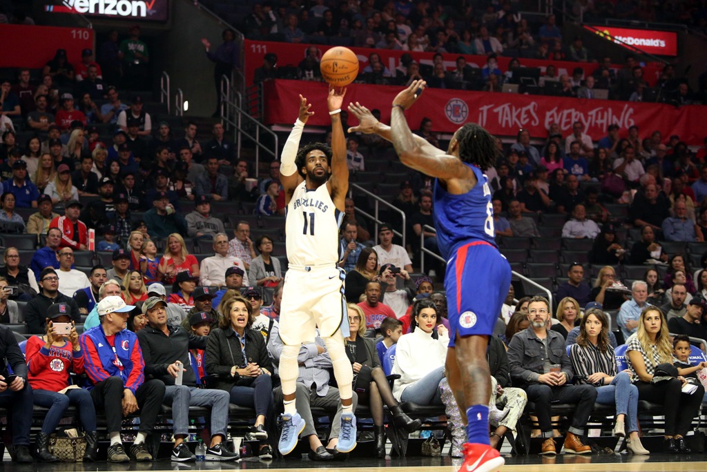 Memphis Grizzlies guard Mike Conley (11) shoots the ball over Los Angeles Clippers center DeAndre Jordan (6) during the first quarter of an NBA game at Staples Center. Kiyoshi Mio