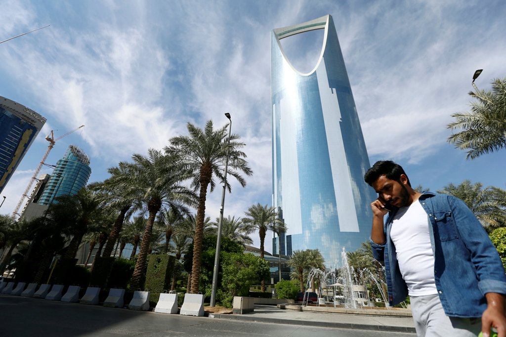 A man speaks on the phone as he walks past the Kingdom Centre Tower in Riyadh, Saudi Arabia, November 5, 2017. REUTERS/Faisal Al Nasser
