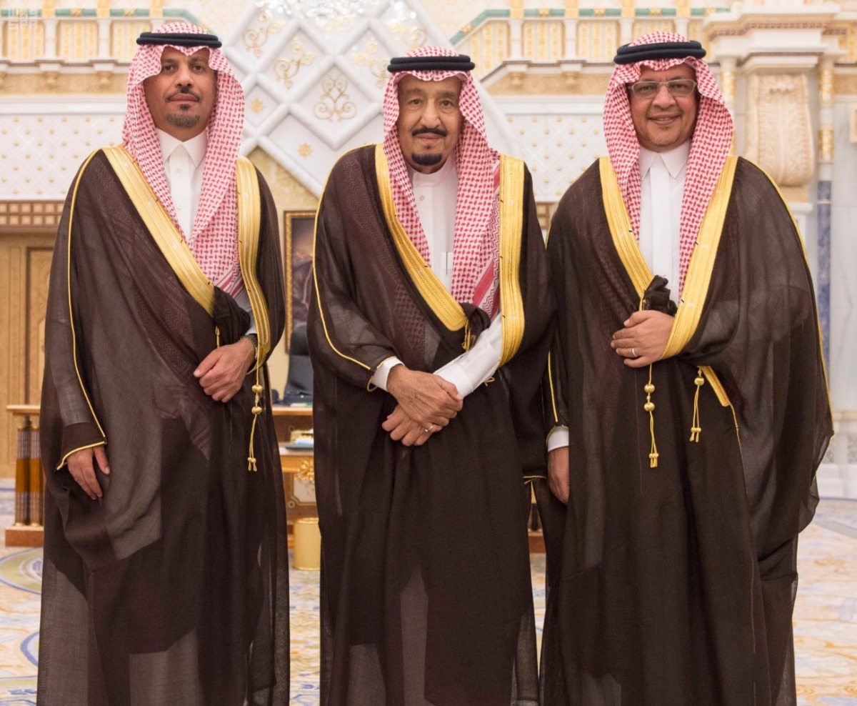 Saudi King Salman bin Abdulaziz Al Saud poses for a photo with National Guard Minister Khaled bin Ayyaf and Economy Minister Mohammed al-Tuwaijri during a swearing-in ceremony in Riyadh, Saudi Arabia, November 6, 2017. Saudi Press Agency/Handout via Reute