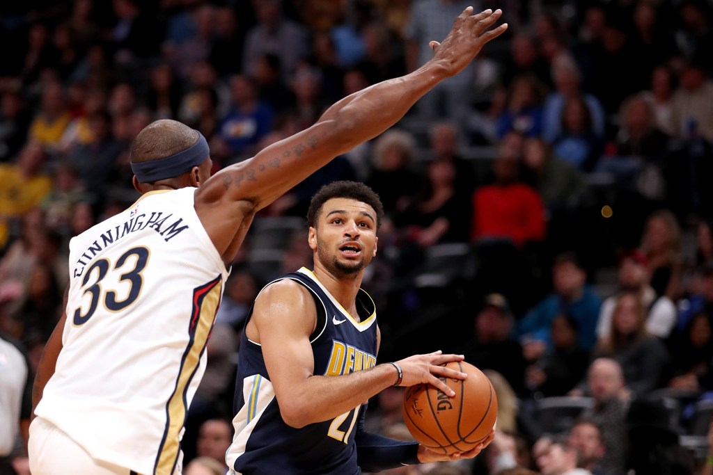 Jamal Murray #27 of the Denver Nuggets drives to the basket against Dante Cunningham #33 of the New Orleans Pelicans at the Pepsi Center on November 17, 2017 in Denver, Colorado. Matthew Stockman/AFP
