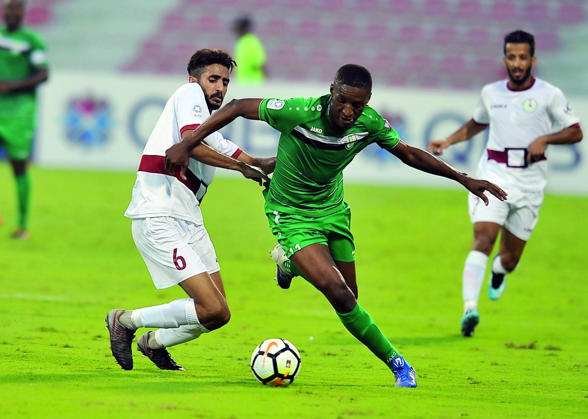 Al Ahli’s Mashel Abdulla (foreground) takes the ball past Al Markhiya’s Salih Mohamed during their QSL match at Al Arabi Stadium yesterday. Pic: Kammutty VP/The Peninsula