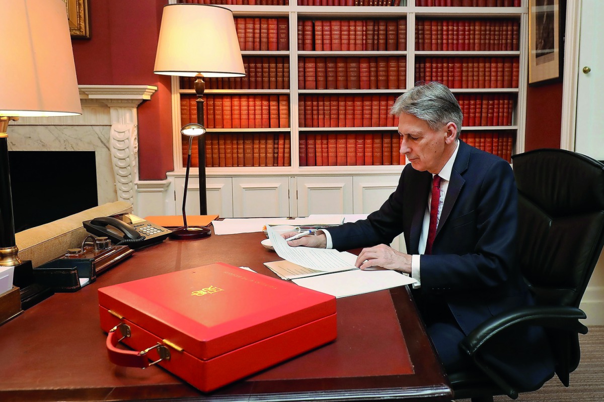 Britain's Chancellor of the Exchequer Philip Hammond poses putting finishing touches to his speech in his office in Downing Street central London on November 21, 2017 on the eve of his 2017 budget announcement. AFP/ Christopher Furlong