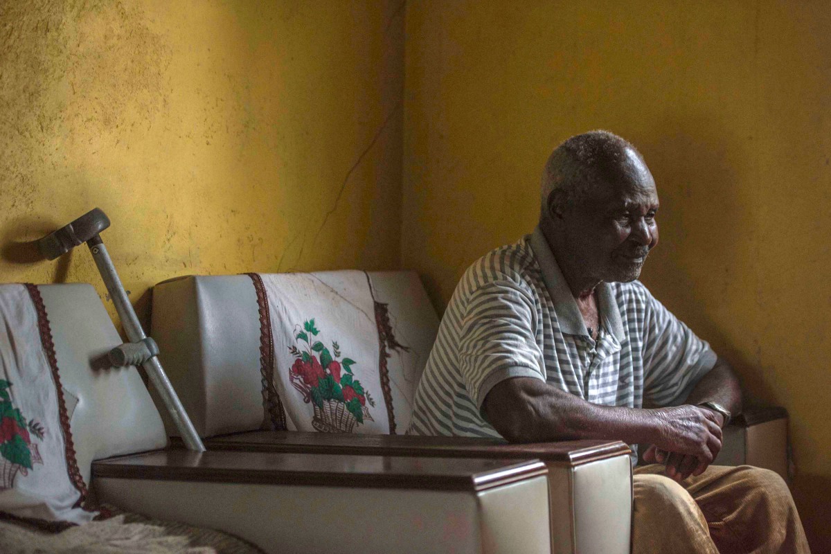 In this photograph taken on November 23, 2017, 93 year-old Zimbabwean Johannes sits on a chair in his home as he speaks about growing up with former Zimbabwean President Robert Mugabe in the village of Kutama some 200kms west of Harare.  AFP / Mujahid Saf