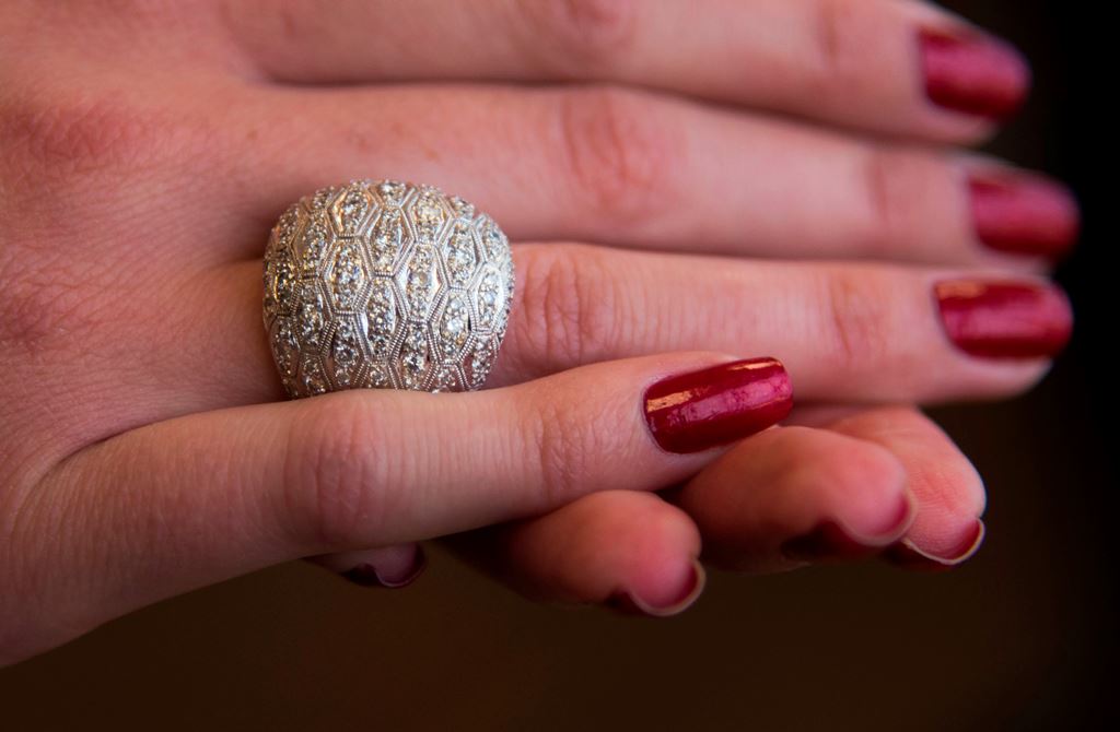 A model shows a solid gold 18K white dome ring, originally a gift from Richard Burton to Elizabeth Taylor, November 29, 2017 at a media preview for the world's first live streaming runway auction of a $25 million collection of rare Chanel fashion as well 