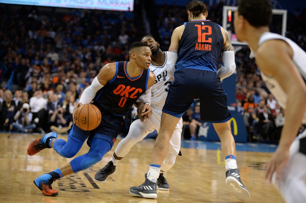  San Antonio Spurs guard Brandon Paul (3) pursues Oklahoma City Thunder guard Russell Westbrook (0) around a screen set by Oklahoma City Thunder center Steven Adams (12) during the second quarter at Chesapeake Energy Arena.  Mark D. Smith 
